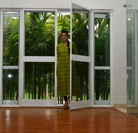 Woman opening a premium insect net door by RK Ecran